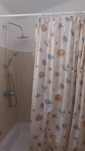 a shower curtain with fish on it in a bathroom at Art room JASMINA with sea view - Bikers and pets are welcome in Starigrad-Paklenica