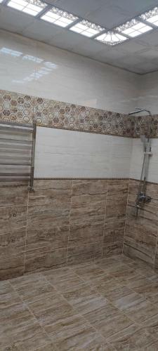um quarto vazio com piso em azulejo e um chuveiro em Luxury Millionere villa em Gabala
