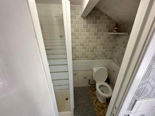 a small bathroom with a toilet and a shower at B&B Runway Blackpool - Minutes From Winter Gardens - Dog Friendly - Exceptionally Quiet - Very Close H&A Social Club in Blackpool