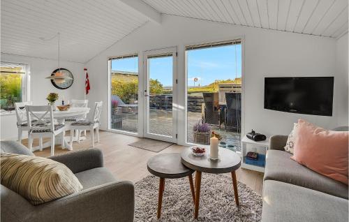 a living room with a couch and a tv and a table at Awesome Home In Haderslev With Kitchen in Haderslev