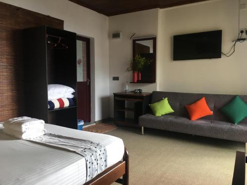 1 dormitorio con cama, sofá y TV en Villa Forest View - No: 50/17 en Kandy