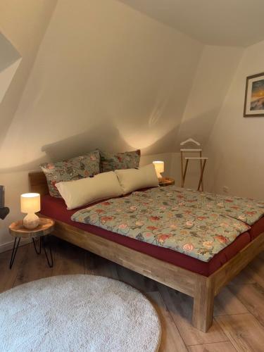 a bedroom with a bed and two lamps and a rug at 4 wunderschöne Ferienwohnungen im Kavaliershaus in Schwerin