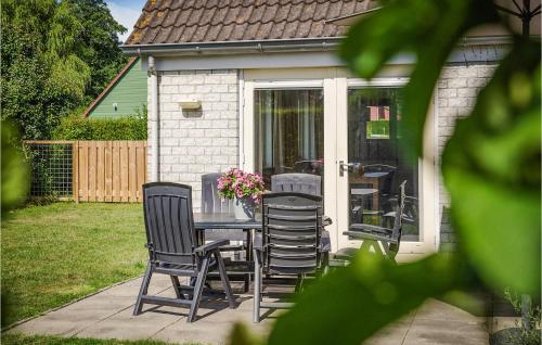 a patio with a table and chairs in a backyard at Oesterbaai -5C2 in Wemeldinge