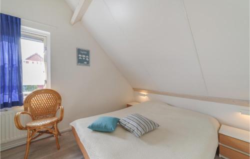a small bedroom with a bed and a chair at Oesterbaai -5c2 in Wemeldinge