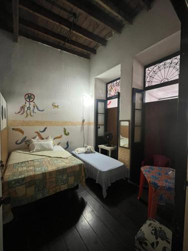 a bedroom with two beds and a window at Hostel Torre Bahia in Salvador