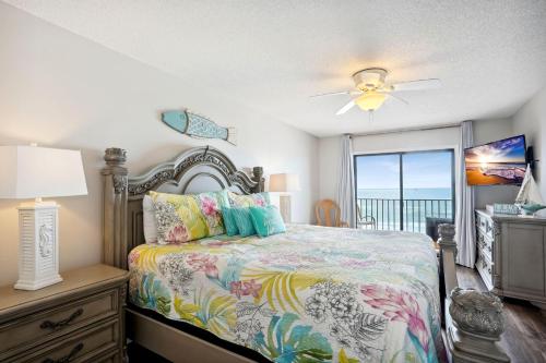 a bedroom with a bed with a view of the ocean at Las Brisas 202 in St. Pete Beach