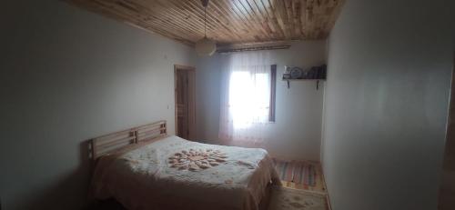 a bedroom with a bed and a window at Manzara Cennet in Macka