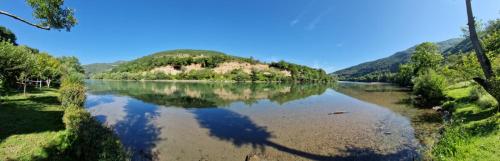a view of a river with mountains in the background at Apartman na Drini in Foča