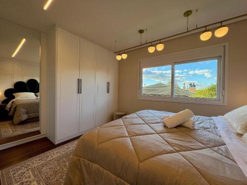 Säng eller sängar i ett rum på Apartamento Beluno 3 dorm Canela by Achei