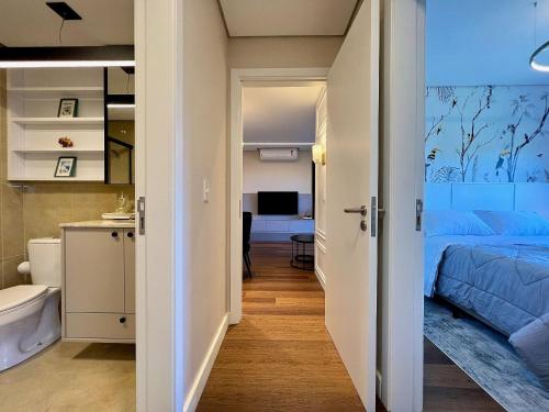um pequeno quarto com uma cama e uma casa de banho em Apartamento Beluno 3 dorm Canela by Achei em Canela