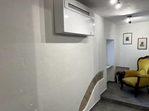 una sala de espera con una silla amarilla y una ventana en Appartamento Porta Maggio II, en Terracina