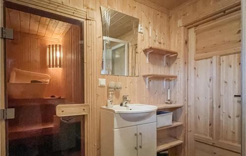 a bathroom with a sink and a mirror at Awesome Home In Reinli With Sauna And 4 Bedrooms in Reinli
