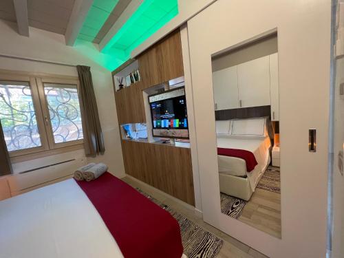 a bedroom with a bed and a tv in a room at Antica Fonte Holiday Homes in San Pantaleo