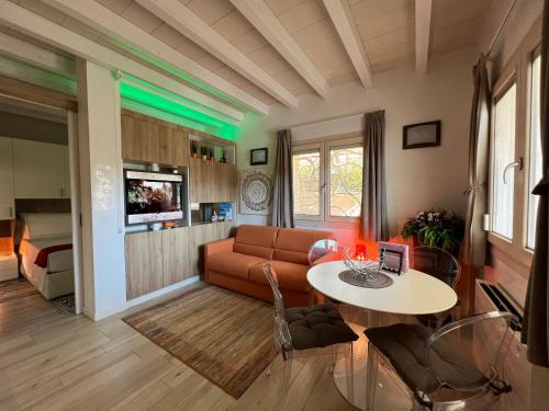 a living room with a couch and a table at Antica Fonte Holiday Homes in San Pantaleo