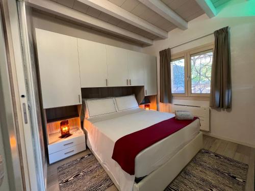 a bedroom with a bed and a window at Antica Fonte Holiday Homes in San Pantaleo