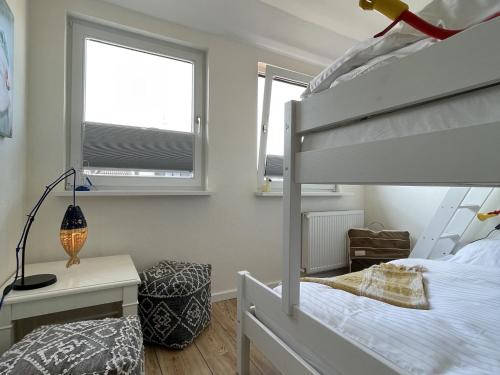 a bedroom with a bunk bed and a desk at Ferienwohnung in Wyk-Boldixum auf Foehr in Boldixum