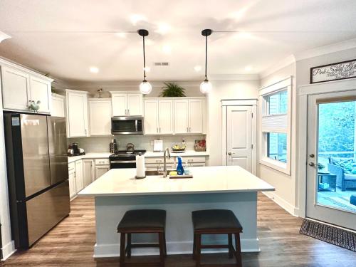 a kitchen with white cabinets and a kitchen island at Pink Sand Hideaway in Hilton Head Island