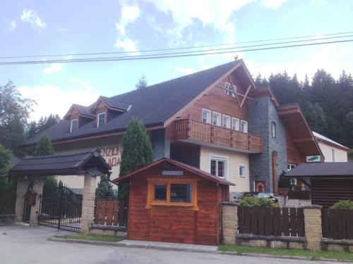a large house with a fence in front of it at Penzion Adam - Makov in Makov