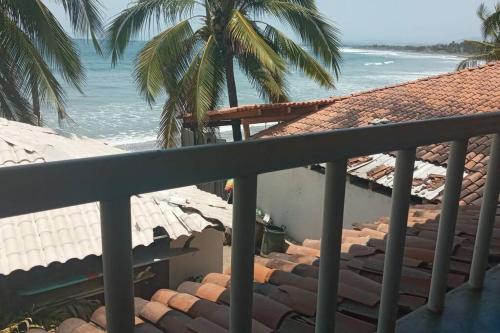 a balcony with a view of the beach at Chucho's mom house in Temalhuacán