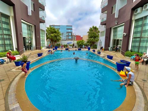 a pool in a building with people playing in it at Appart Hôtel Founty Beach in Agadir