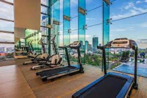 a gym with a large window with a view of a city at Setia Sky 88 @D'miko Home Stay in Johor Bahru