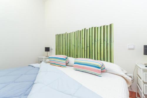 a bedroom with a bed with two pillows on it at Bright duplex apartment for families-VICALV in Madrid