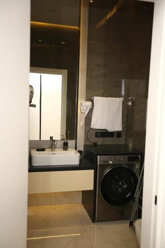 a bathroom with a sink and a washing machine at Sea Breeze in Baku