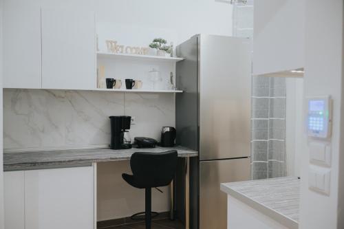 a kitchen with a counter and a black chair at Comfy and Stylish apartment Thessaloniki in Thessaloniki