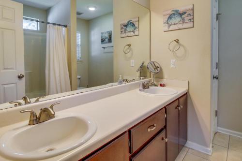 a bathroom with two sinks and a mirror at Pet-Friendly Savannah Rental with Community Pool! in Savannah