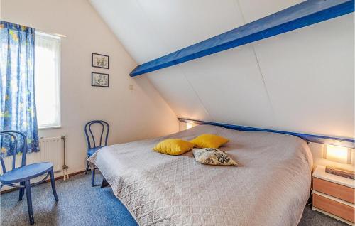 a bedroom with a bed with yellow pillows on it at Oesterbaai -5c1 in Wemeldinge