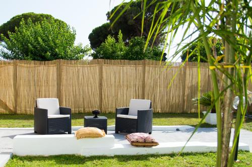 a group of chairs sitting on a table in a yard at VILLA AMBROSIA 172 A in Terracina