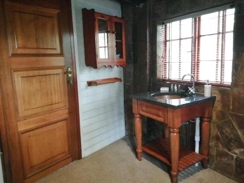 a bathroom with a sink next to a door at Ikamu's lodge in Germiston