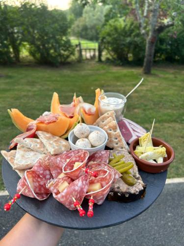 a plate of food with different types of food on it at Demeure du Vallon - Chambres d'Hôtes de Charme in Azerat