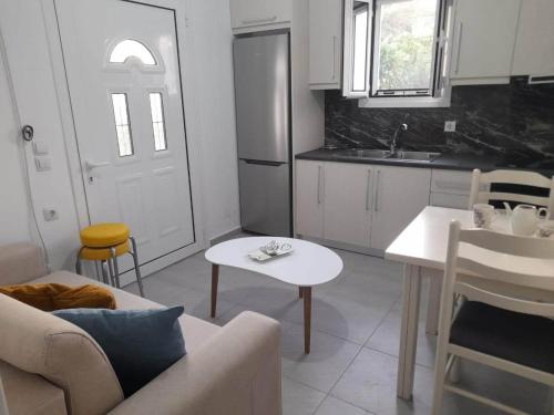 a kitchen with a couch and a table in a room at Katerina's Relaxing Apartment in Sarandë