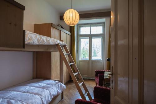 a bedroom with a bunk bed and a window at ROMANTICO BILOCALE CON PANORAMA MOZZAFIATO in Nova Levante