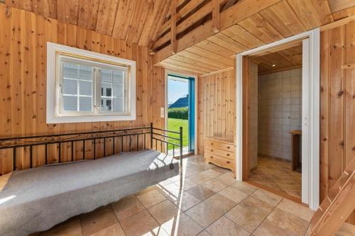 a bedroom with a bed in a room with a window at Villa Krågenes in Farsund