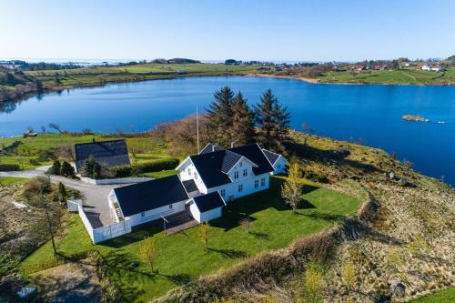 an aerial view of a house on the edge of a lake at Villa Krågenes in Farsund