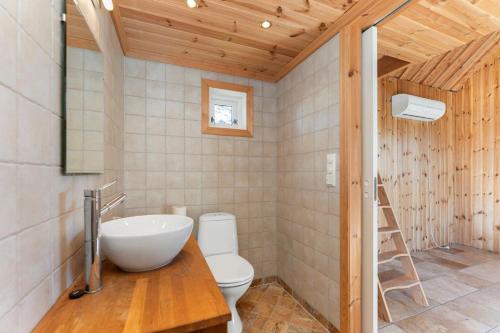 a bathroom with a white sink and a toilet at Villa Krågenes in Farsund