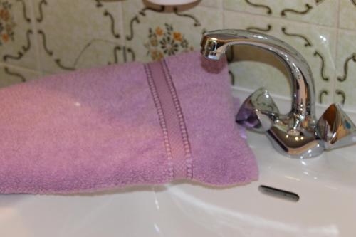 a purple towel sitting on top of a sink at Haus Tirolerland in Mayrhofen