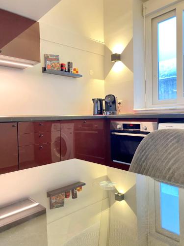 a kitchen with a glass table in a kitchen at Duplex Cosy au Cœur du Vieux-Nice in Nice