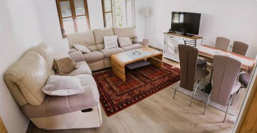 a living room with a couch and a table at Apartman "EXCLUSIVE" in Bihać