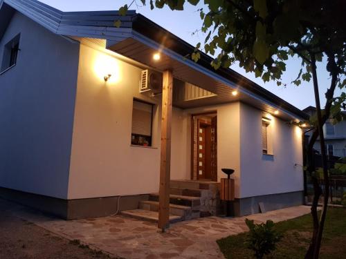 a house with lights on the side of it at Apartman "EXCLUSIVE" in Bihać