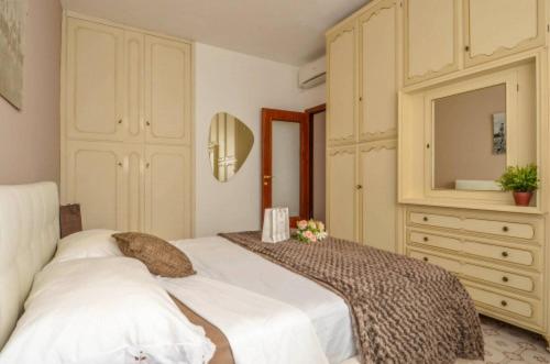 a bedroom with two beds and a dresser with a mirror at Sea La Vie in Moneglia