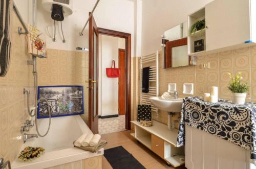 a bathroom with a tub and a sink and a shower at Sea La Vie in Moneglia