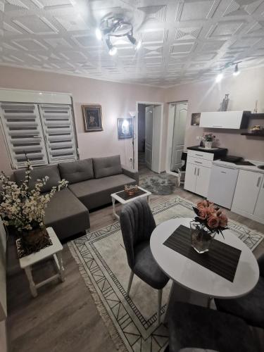 a living room with a couch and a table at DJERDAN in Vranje