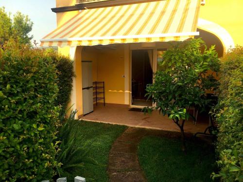 a yellow house with a yellow awning on a patio at Pizzo Beach Club in Pizzo