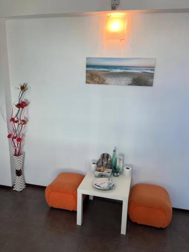 a table and two orange chairs in a room at HOTEL KREDO in Sliven