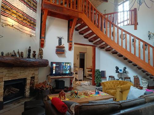 a living room with a couch and a staircase at Ikamu's lodge in Germiston