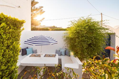 a patio with a table and an umbrella at To Pyrgaki Kos in Kos Town
