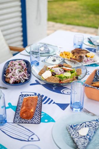 a blue and white table with plates of food on it at To Pyrgaki Kos in Kos Town
